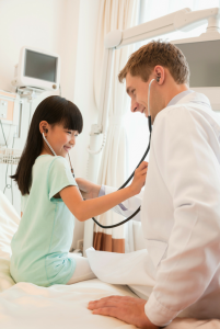 Healthcare Scenario, Child Wearing Stethoscope and Trying it on Doctor